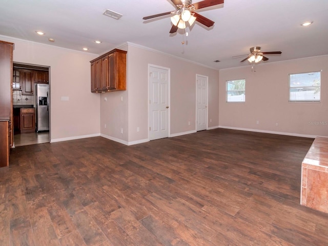 unfurnished living room featuring crown molding, ceiling fan, and dark wood-type flooring