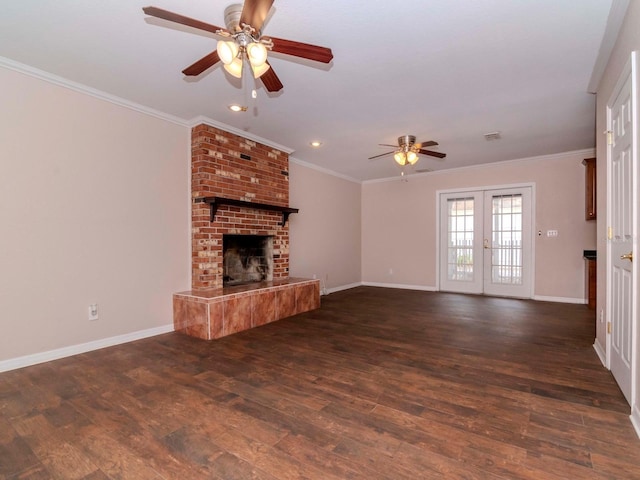 unfurnished living room featuring french doors, a brick fireplace, ceiling fan, ornamental molding, and dark hardwood / wood-style flooring