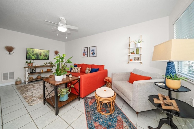 tiled living room with ceiling fan