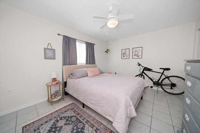 bedroom with ceiling fan and light tile patterned flooring