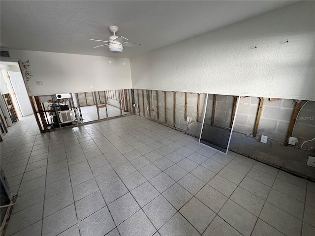 tiled empty room featuring ceiling fan