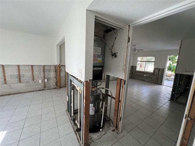 interior space featuring light tile patterned floors and a textured ceiling