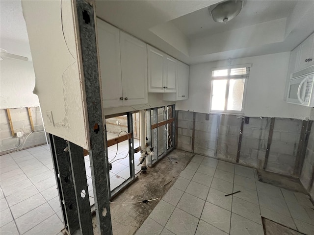 interior space with ceiling fan and light tile patterned floors