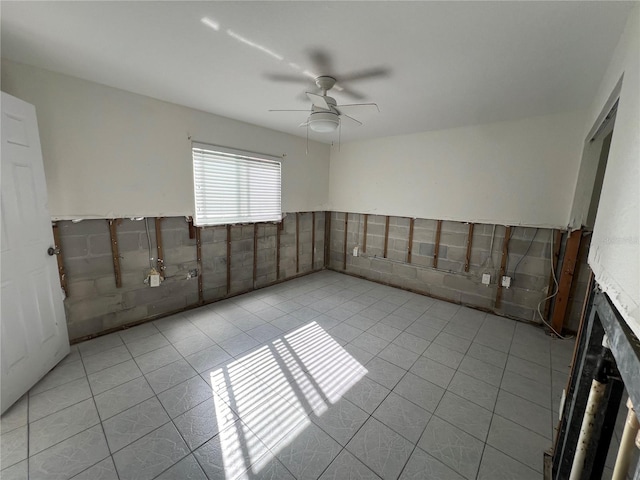 spare room featuring ceiling fan and light tile patterned flooring