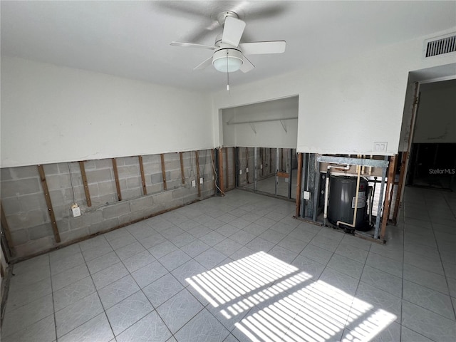 spare room with ceiling fan and light tile patterned flooring