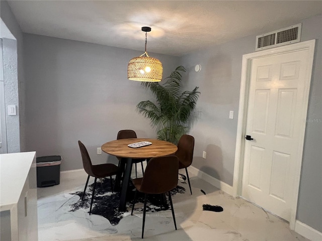 2704 2nd St Unit 7, Indian Rocks Beach, FL 33785 - dining room featuring light marble finish flooring and baseboards