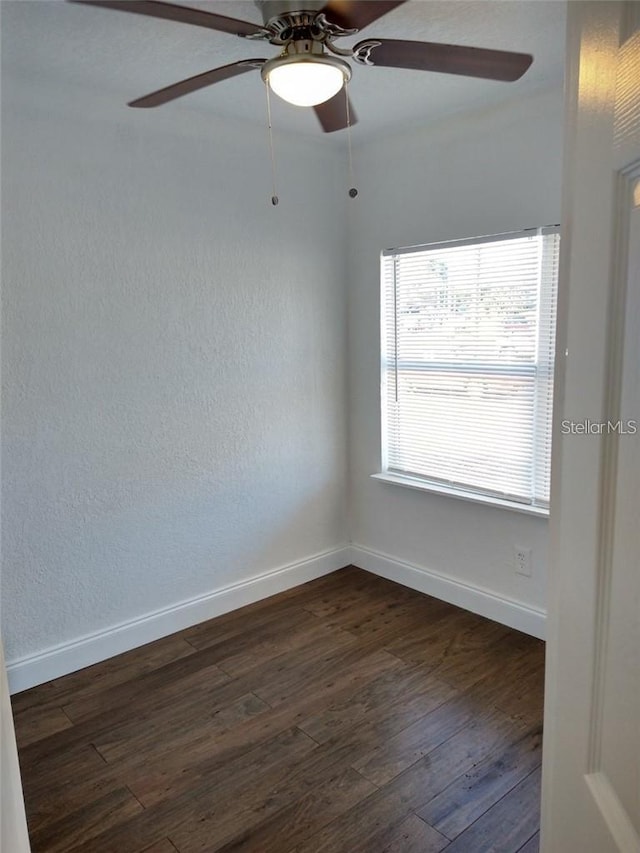 empty room featuring ceiling fan and dark hardwood / wood-style floors