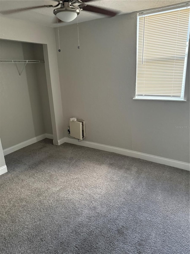 unfurnished bedroom featuring a closet, carpet, and ceiling fan