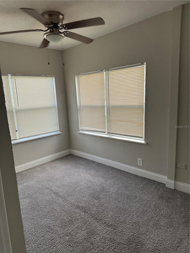 carpeted empty room featuring ceiling fan