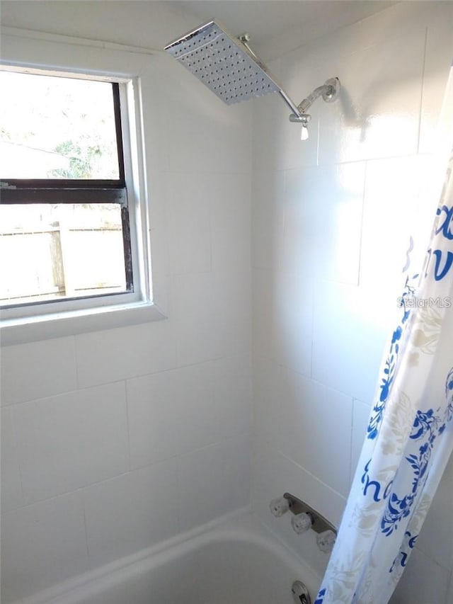 bathroom with shower / tub combo with curtain