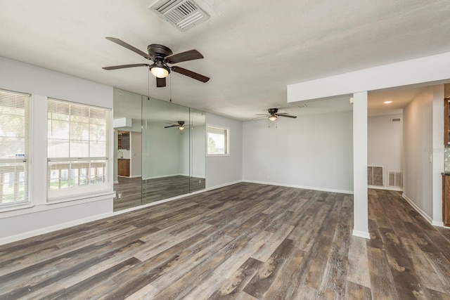 spare room featuring ceiling fan and dark hardwood / wood-style floors