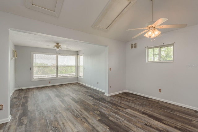 empty room with a wealth of natural light, ceiling fan, and dark hardwood / wood-style floors