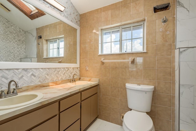 bathroom featuring tile walls and toilet