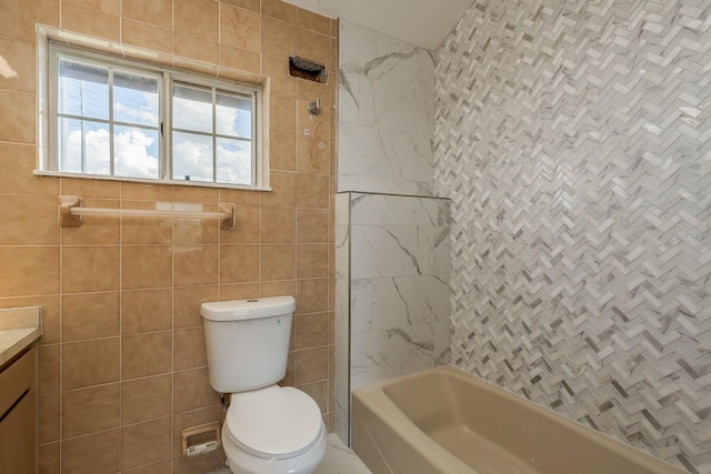 full bathroom with tile walls, vanity, toilet, and tiled shower / bath