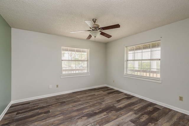 empty room featuring ceiling fan, a textured ceiling, plenty of natural light, and dark hardwood / wood-style flooring