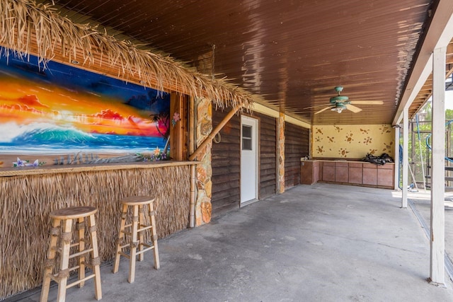 view of patio / terrace with exterior bar and ceiling fan