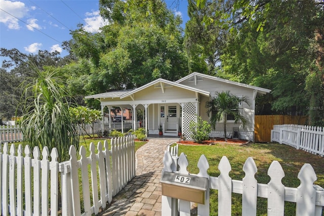 bungalow-style house featuring a front yard and covered porch