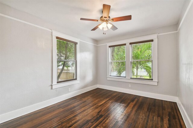 empty room with dark wood-type flooring and ceiling fan