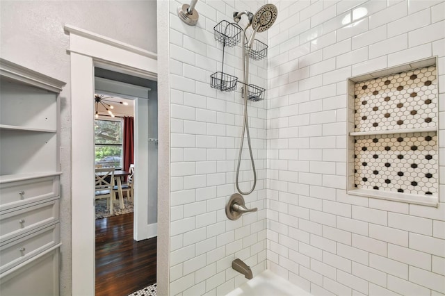 bathroom featuring ceiling fan, tiled shower / bath, and hardwood / wood-style flooring