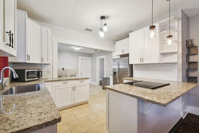 kitchen with pendant lighting, white cabinets, kitchen peninsula, and stainless steel appliances