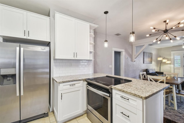 kitchen with a notable chandelier, appliances with stainless steel finishes, kitchen peninsula, and white cabinetry