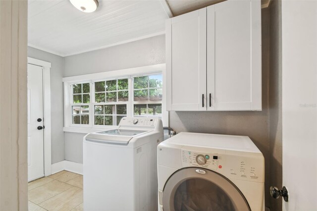 laundry room with cabinets, independent washer and dryer, and light tile patterned flooring