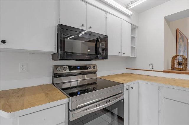 kitchen featuring white cabinetry and electric range