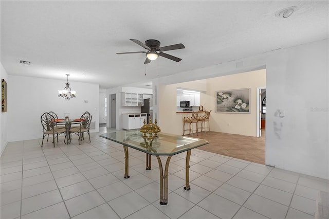 interior space featuring a textured ceiling and ceiling fan with notable chandelier