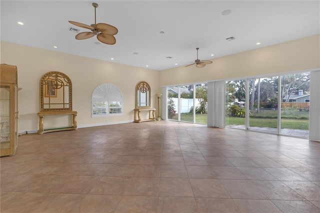 unfurnished living room featuring light tile patterned floors and ceiling fan