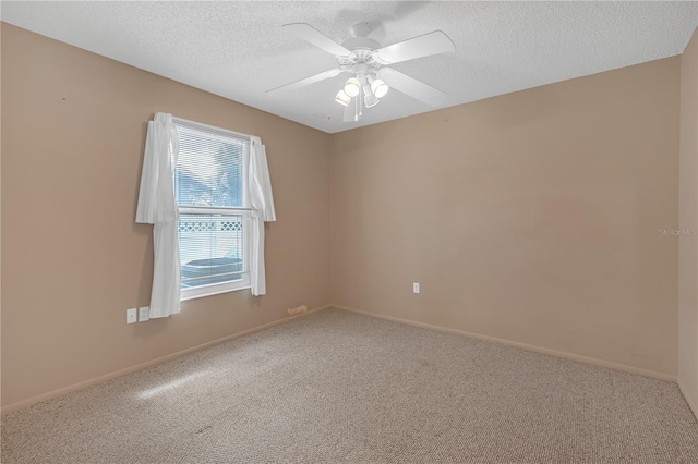 spare room featuring ceiling fan, carpet floors, and a textured ceiling