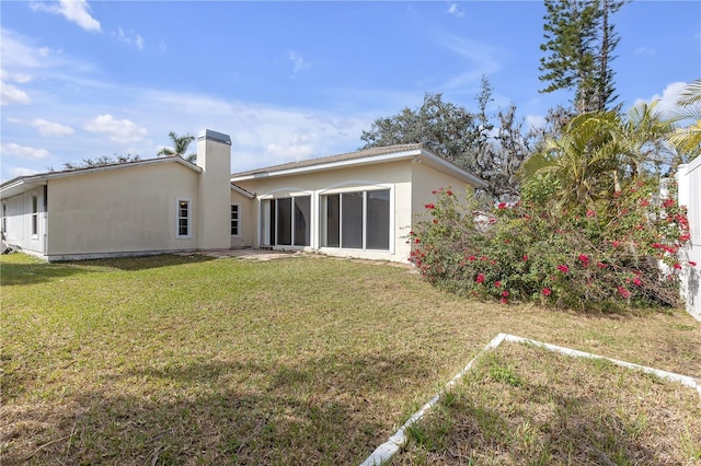 rear view of house with a lawn