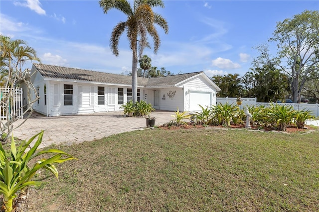 view of front facade featuring a front yard and a garage