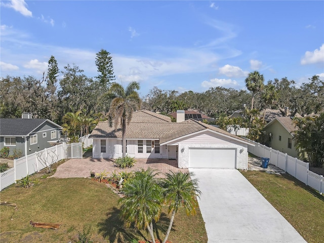 view of front of home featuring a front yard and a garage