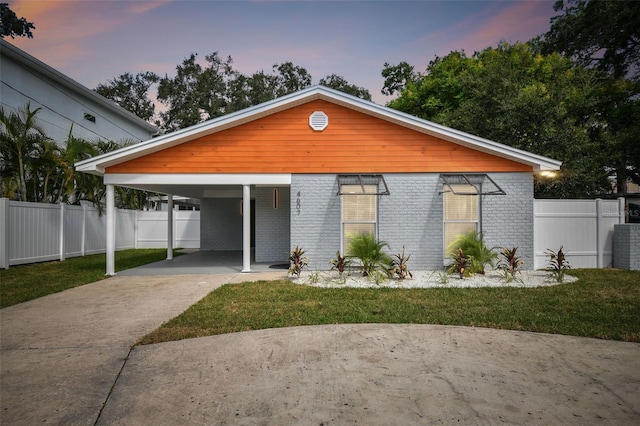 contemporary house featuring a lawn and a carport