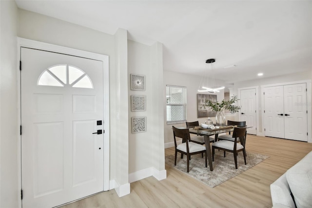 entryway with recessed lighting, baseboards, and light wood finished floors