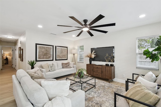 living area with recessed lighting, baseboards, light wood-type flooring, and ceiling fan