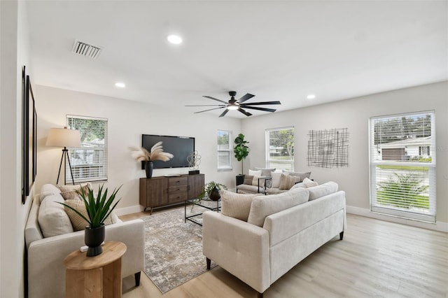 living room featuring recessed lighting, visible vents, and light wood finished floors