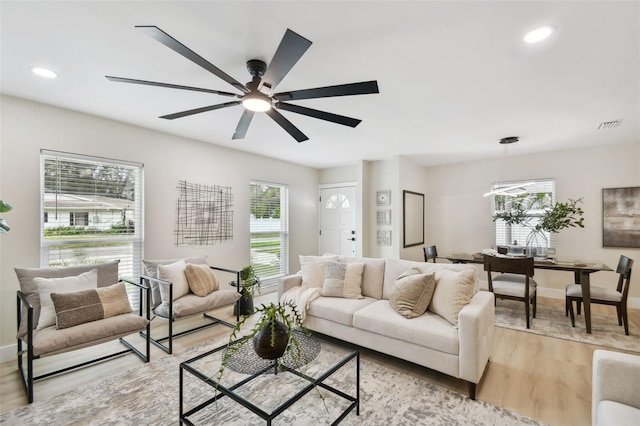 living room with recessed lighting, visible vents, a healthy amount of sunlight, and light wood-style flooring