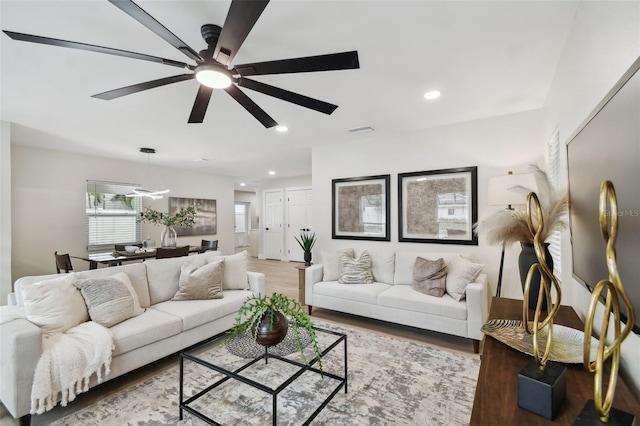 living room with visible vents, recessed lighting, a ceiling fan, and wood finished floors