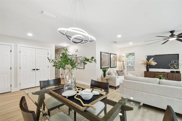 living room with visible vents, recessed lighting, light wood-type flooring, and baseboards