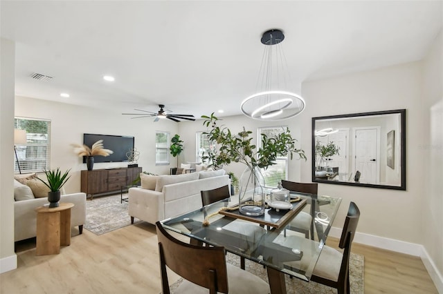 dining area with visible vents, baseboards, recessed lighting, ceiling fan with notable chandelier, and light wood-style floors