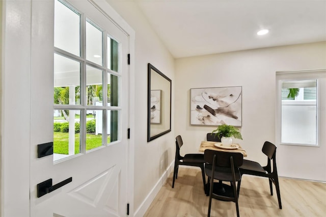 dining space with recessed lighting, baseboards, and wood finished floors