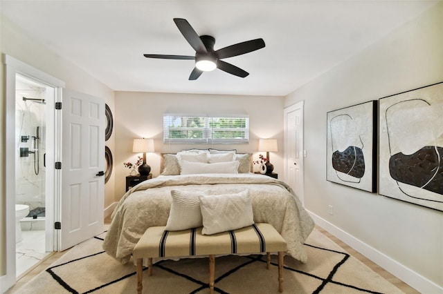 bedroom featuring connected bathroom, baseboards, and ceiling fan