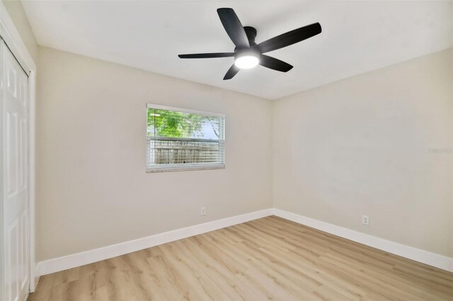 unfurnished bedroom with a closet, ceiling fan, light wood-type flooring, and baseboards