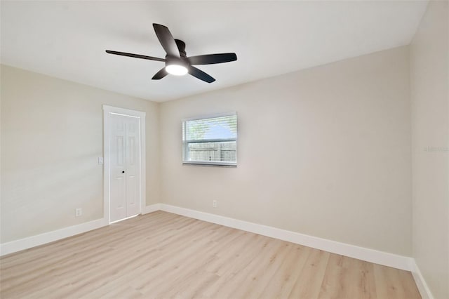 spare room with ceiling fan, baseboards, and wood finished floors