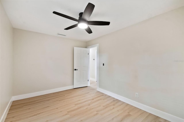 spare room with visible vents, baseboards, and light wood-type flooring