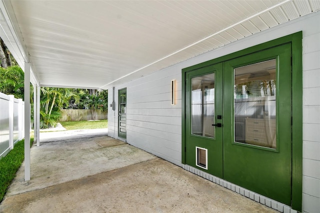 view of patio with french doors and fence