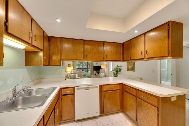 kitchen featuring white dishwasher, sink, kitchen peninsula, and light tile patterned flooring