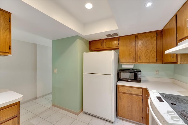 kitchen with white appliances and light tile patterned floors