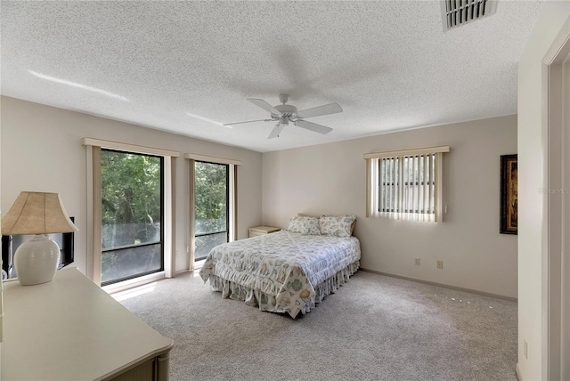 carpeted bedroom featuring a textured ceiling, access to outside, and ceiling fan